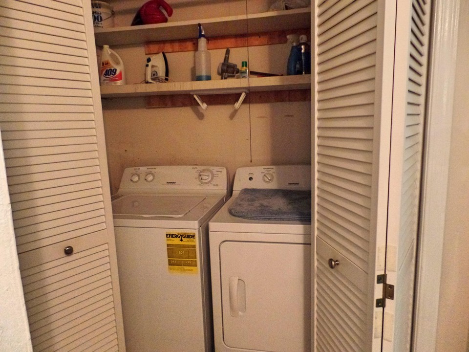 utility closet with shelves on first floor