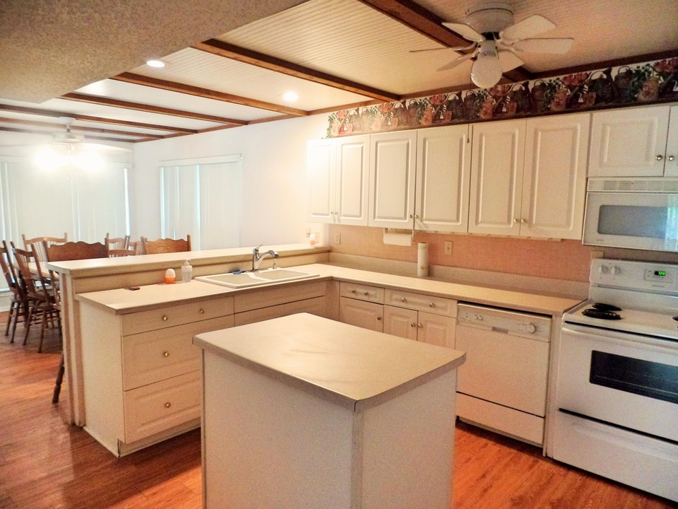 kitchen with breakfast bar open to dining