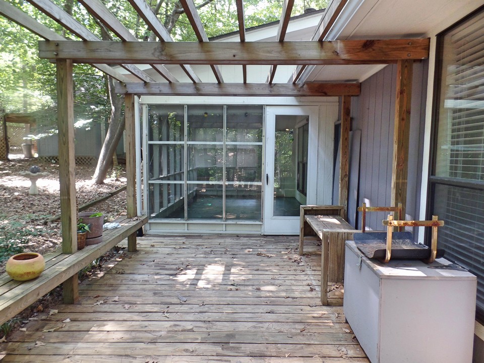sunroom opens to deck with pergola