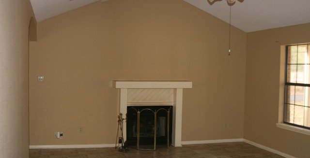 nice size living room with wood burning fireplace.