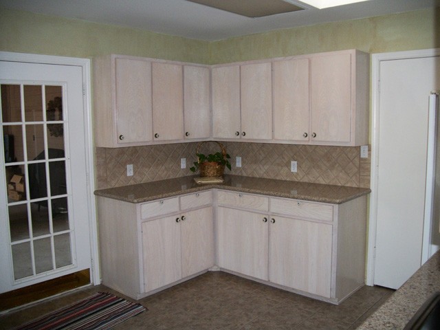lots of cabinets with a walk-in pantry  to the right.