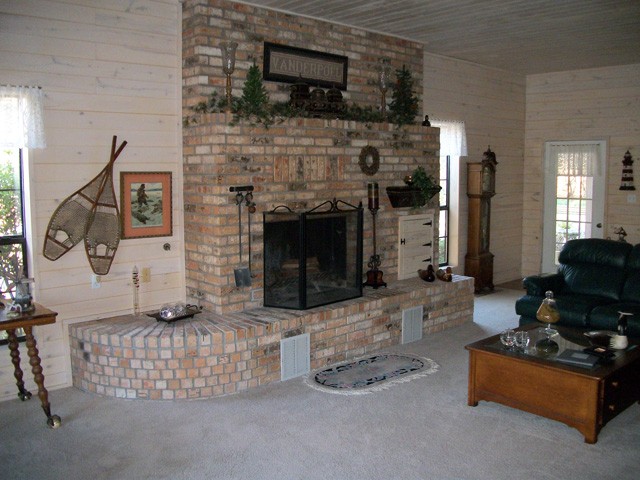 brick fireplace which is a highlight of the large living room.