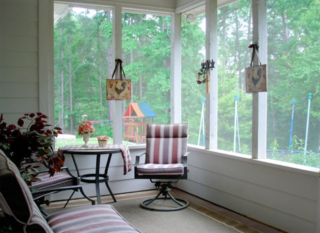 large screened porch with woods view.