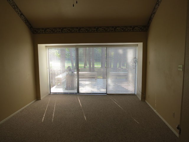 master bed view thru the glass sliding doors to the golf course.