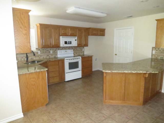 open kitchen with granite c'tops.