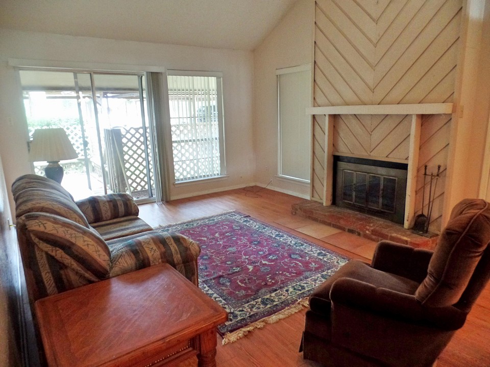 living with fireplace and exit to private deck