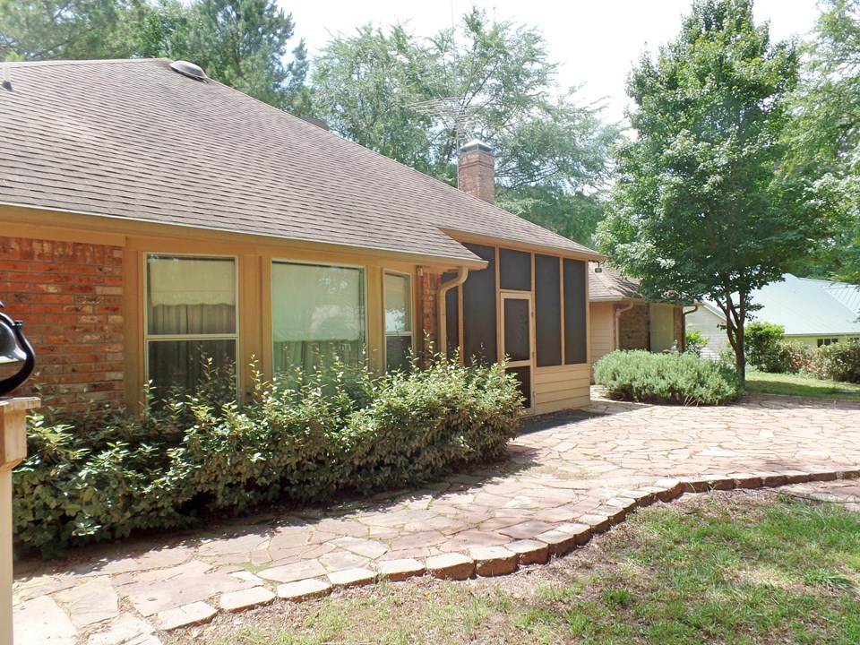 back of home with pavestone patio