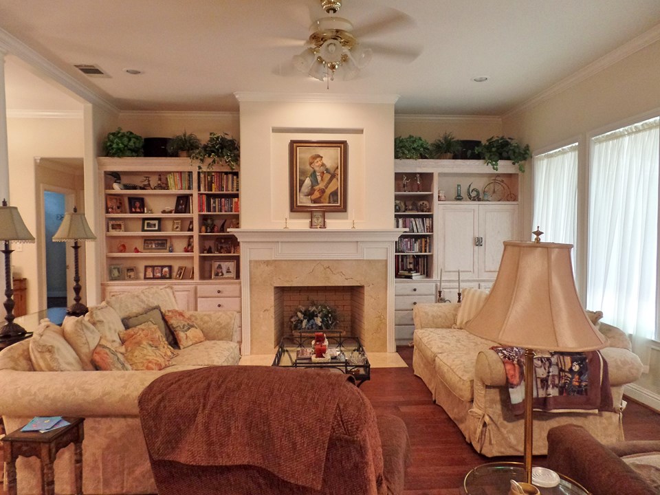 spacious living with wood floors, built-ins, fireplace