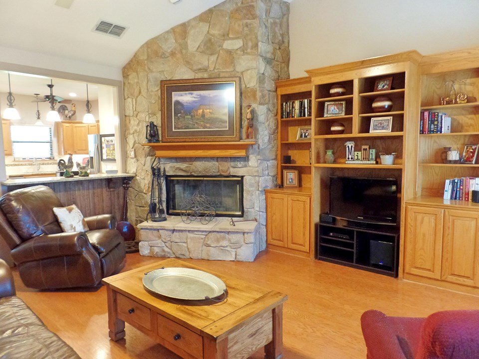 hardwood floors, corner stone fireplace and built-ins