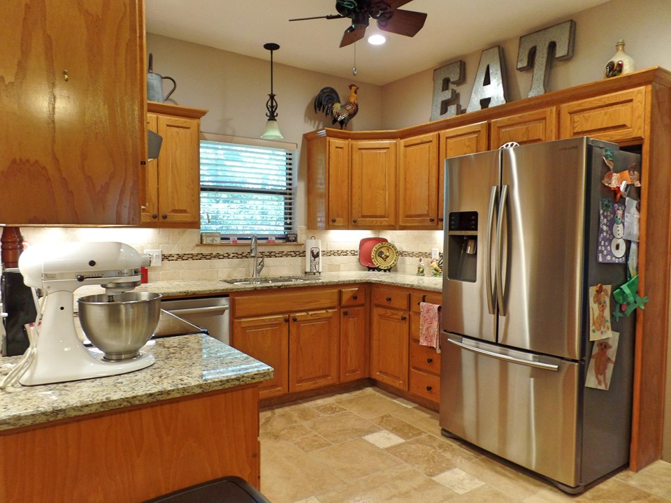 kitchen with granite and undercabinet lighting
