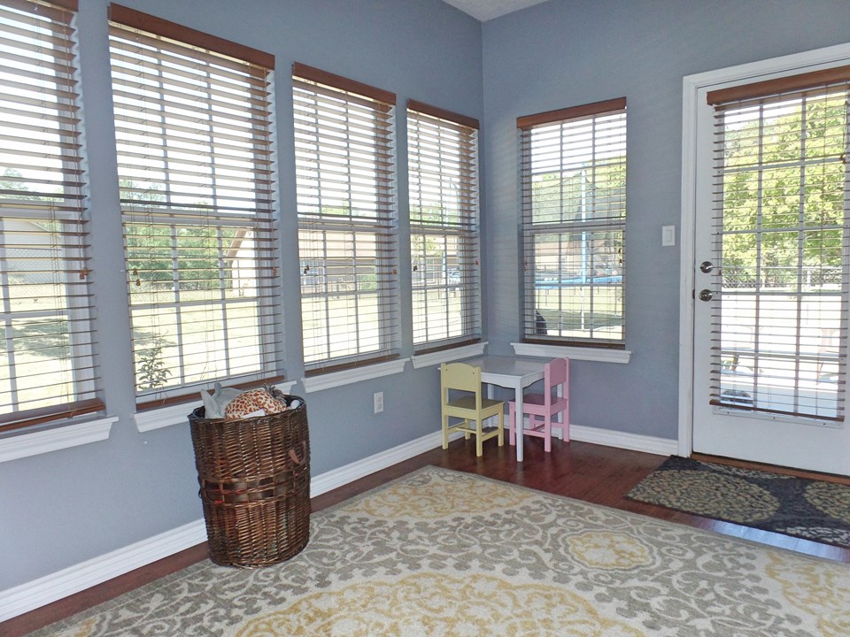 light bright sunroom with exit to back patio