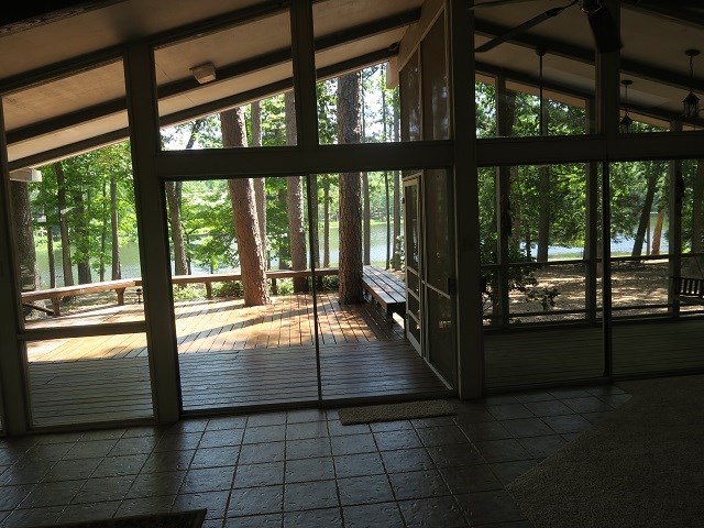 lr & dining room wall of windows view of the lake