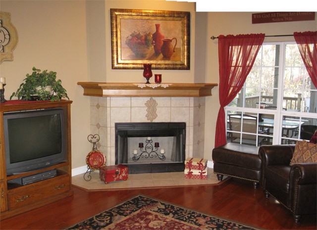 attractive lr with wood fireplace and woods view.