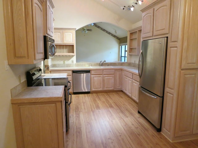 open kitchen with stainless steel appliances.