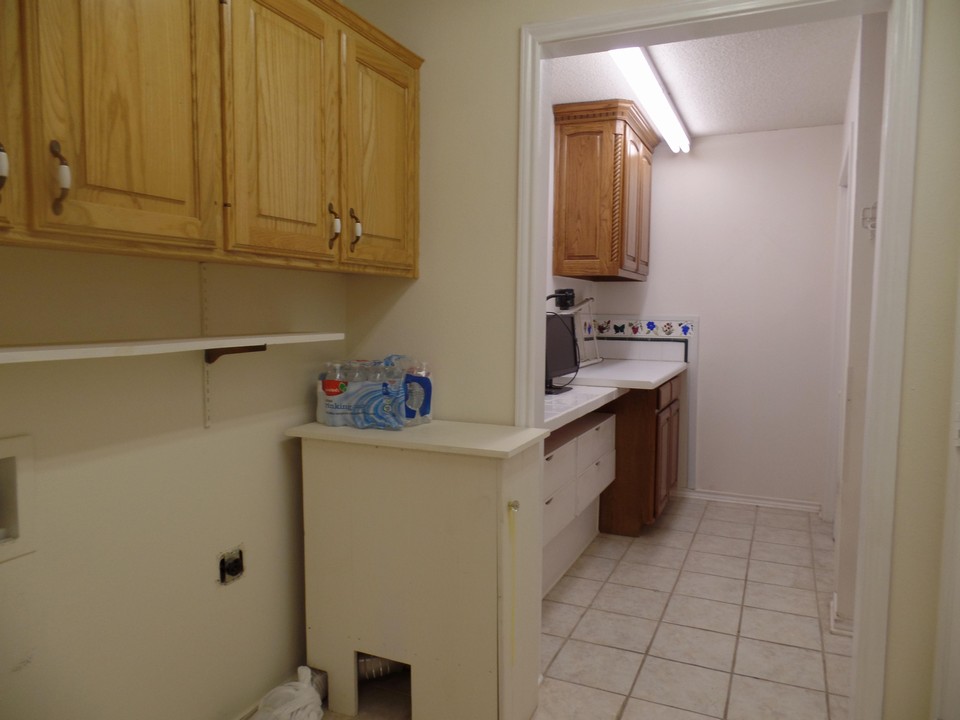 large utility room with lots of storage and folding table