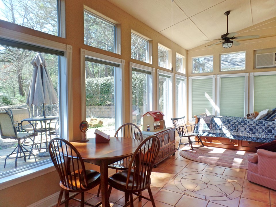 light bright sunroom with view to landscaped yard on #5 tee beyond