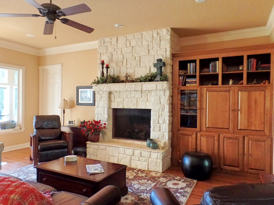 living with beautiful stone fireplace and custom built-ins