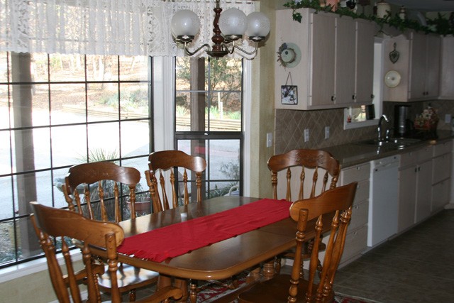 dining room with a super view of the woods through the bay window.