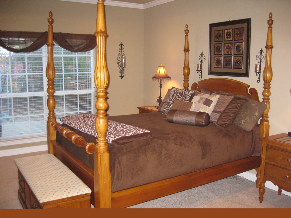 large master bed with woods view.